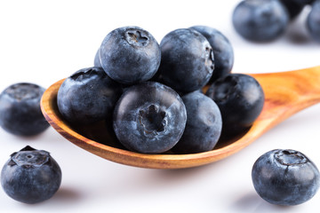 Fresh blueberries in wooden spoon