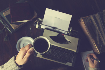 Man writing on old typewriter.