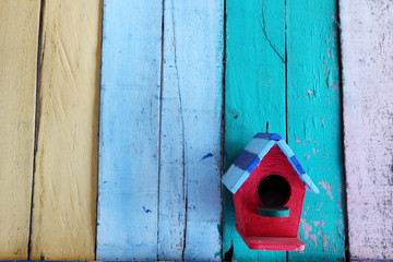 bird house on colorful panel