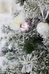Fototapeta na wymiar Snowy christmas tree with decorations