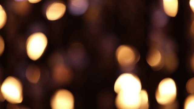Abstract glittering lights, gold background, a real shot video in the blur