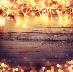 Christmas wooden background with light garland