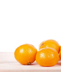 A mandarine on wooden table.