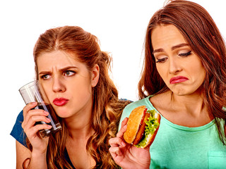 Unhappy couple girl eating fast food.