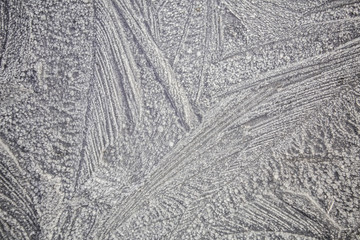 Ice patterns on winter glass . Frozen flowers. Frozen fern. White color. Macro lens.