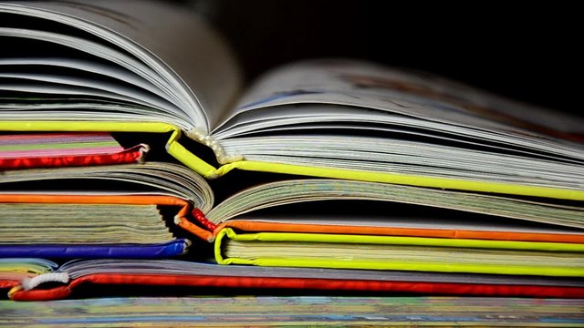 A pile of childrens books with a pencil and apple on top. Teachers pet. books stacked with formulas fund, education. 
