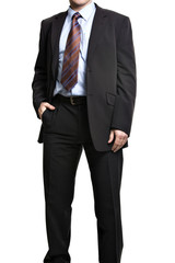 Unrecognizable businessman in suit standing with hand in pocket