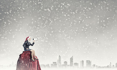 Female Santa making announcement