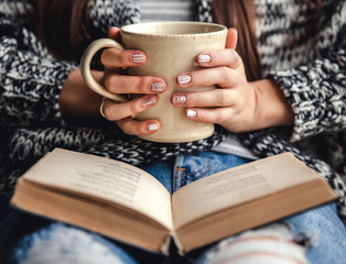 girl having a break with cup of fresh coffee after reading books or studying - 97972018