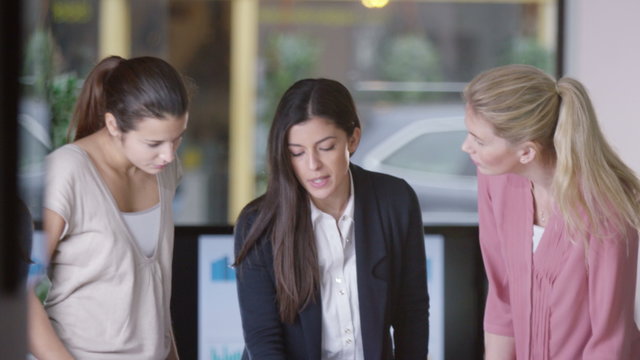  Female casual creative business team brainstorming for ideas in a meeting
