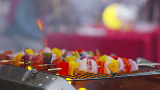 Close up on vegetable kebabs cooking on a bbq