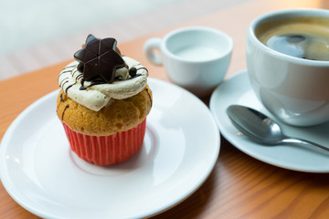 Chocolate cupcake, coffee, and milk
