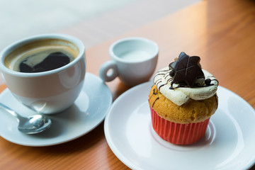 Chocolate cupcake, coffee, and milk
