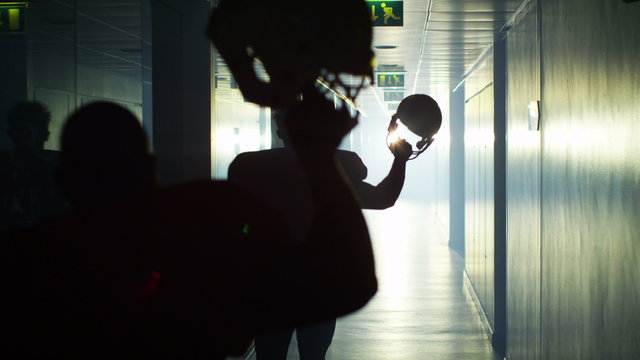  Excited American football team celebrate a victory as they run through tunnel