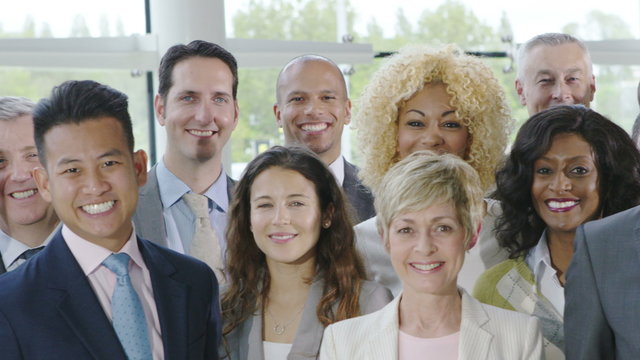  Portrait of large diverse business group smiling at the camera