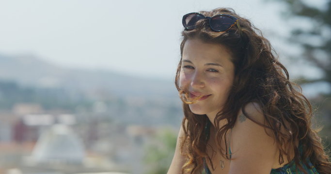  Portrait of attractive smiling woman in Italian city. 