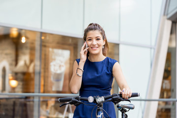 Naklejka na ściany i meble Young woman commuting on bicycle