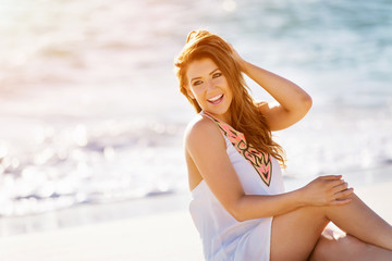 Young woman sitting on the beach