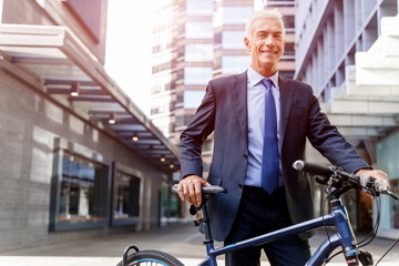 Fototapeta na wymiar Successful businessman riding bicycle