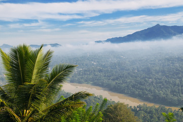Fototapeta na wymiar mountain, town and river in the morning mist (top view)