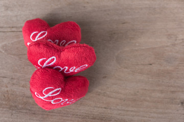 Red heart items on brown wood background