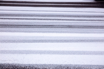 snowy tire tracks on winter road