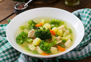 Chicken soup with broccoli, green peas, carrots and celery 