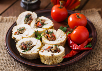 Baked chicken rolls with mushrooms and paprika on brown plate