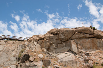  granite rock and sky with clouds on background.