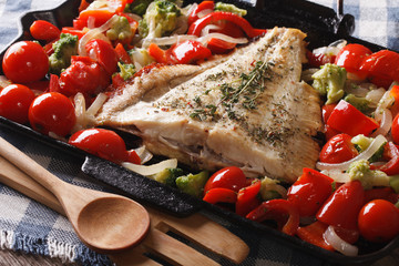 Homemade flatfish with vegetables close-up in a pan. Horizontal
