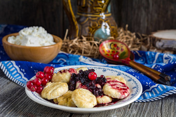 Ricotta gnocchi with sweet berry sauce on plate