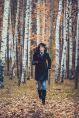 Fashion woman running in autumn park