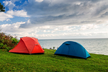 Two camping tents facing the sea