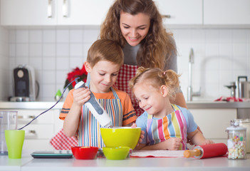 Happy family preparing cookies for Christmas eve
