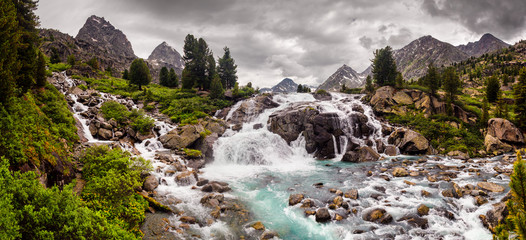 Mountain landscape with waterfall and peaks