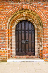 old door of medieval Cistercian monastery in Kolbacz, Poland