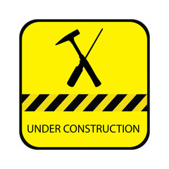 Yellow under construction road sign, with screwdriver, hammer and text under construction