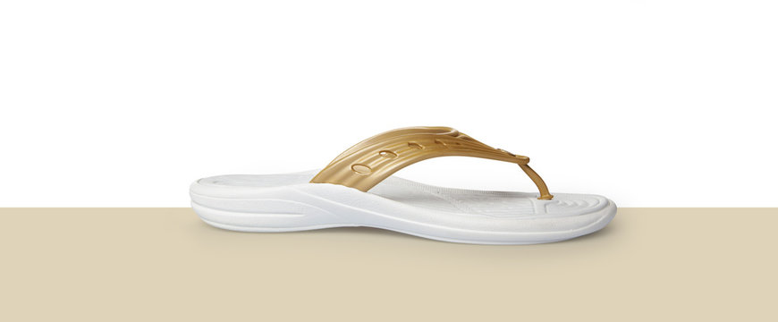 Gold and white flip flops