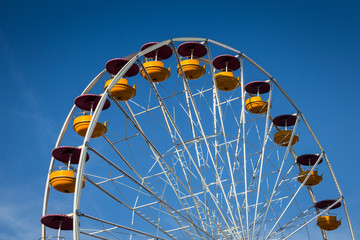 Ferris wheel over blue sky