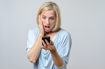 Surprised woman looking at her mobile phone
