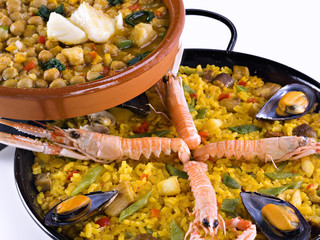 Close up of a paella and a potage of chick-peas