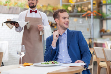 Attractive man has business meeting in restaurant