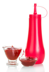 Ketchup in gravy boat and bottle isolated on white