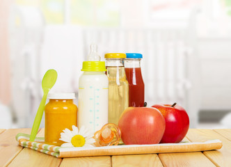 Set of baby food and fresh fruit on the child's room 