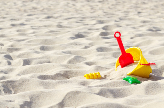 Toys on the sand - Powered by Adobe