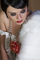 beautiful brunette girl 20s style flapper with jewels and white
