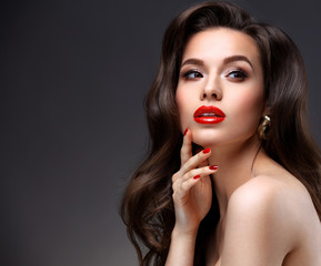 Beauty Model Woman with Long Brown Wavy Hair. Healthy Hair and Beautiful Professional Makeup. Red...