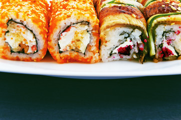 Set of rolls with crab, cream cheese and masago on a plate