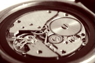 Gears old mechanical watches. Pendulum, cogs under the hood. Close up view, selective focus. Vintage toning.