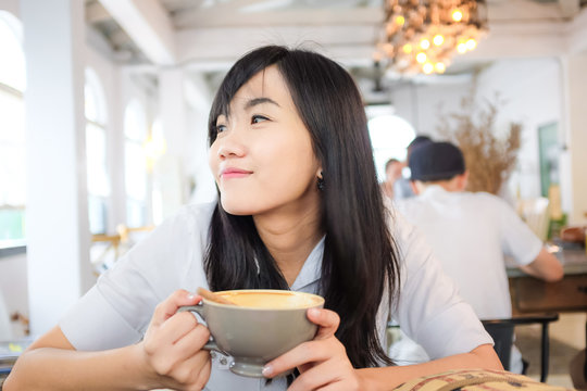 Asian young woman hold coffee cup